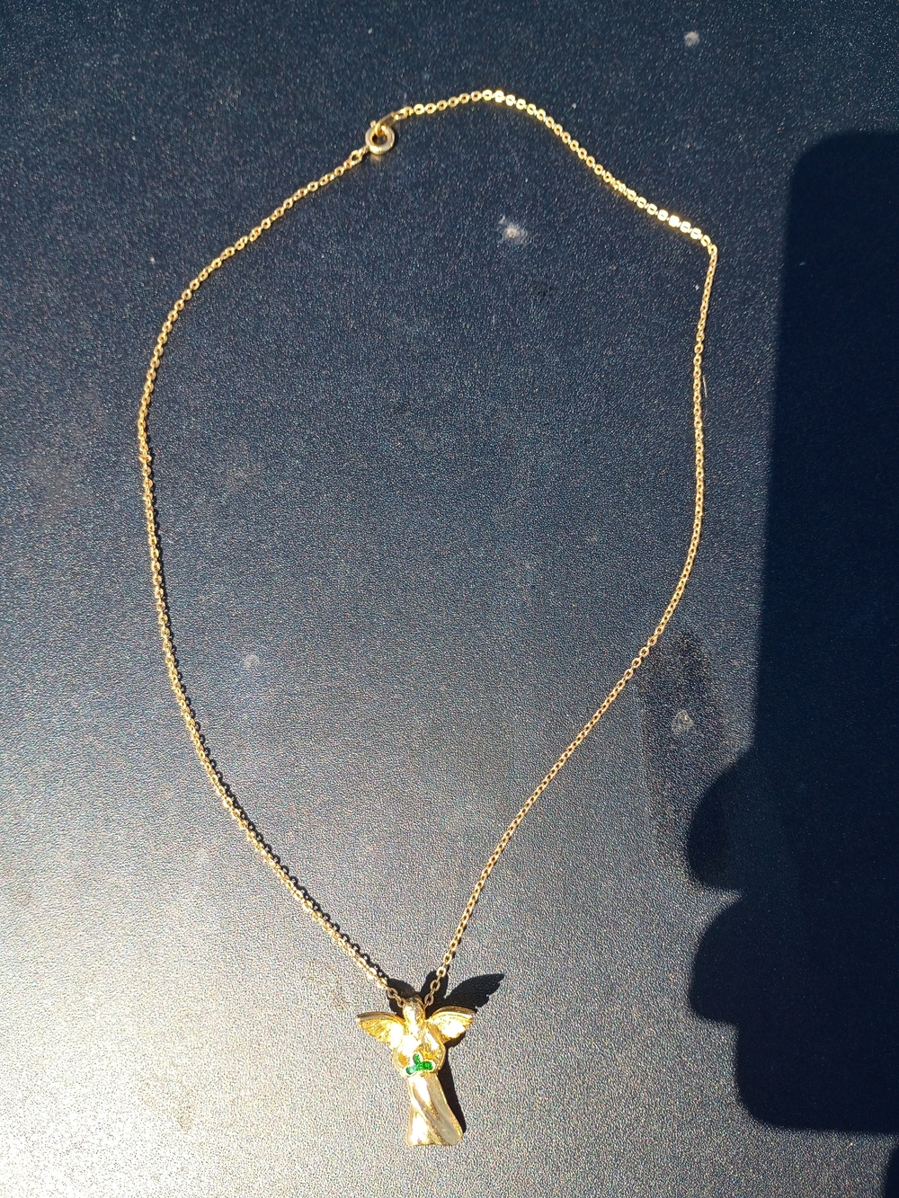 vintage Avon gold-tone angel necklace with a green enamel shamrock.